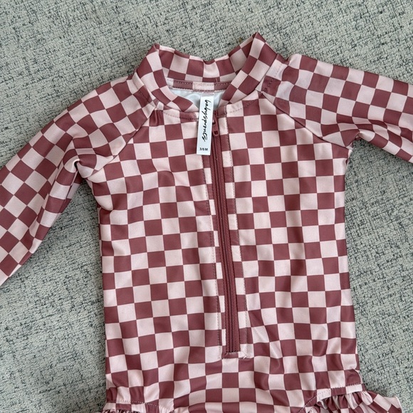 Kids Checkered Rashguard in Pink by Ruffle Butts - Picture 2 of 3